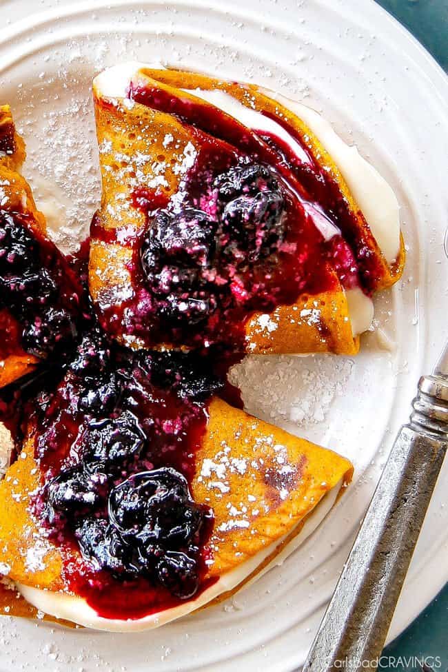 Easy Blender Brown Sugar Carrot Cake Crepes are my family's favorite crepes! Stuffed with silky sweet Cream Cheese and smothered in the most amazing Blueberry Sauce - these are addicting and so fun!!