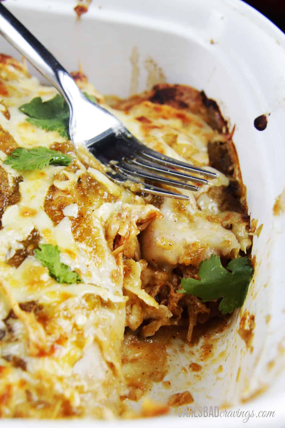 up close of half eaten salsa verde chicken enchiladas