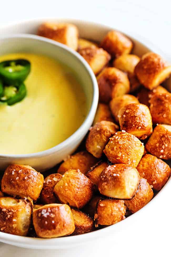 golden pretzel bites topped with sea salt stacked on top of each other