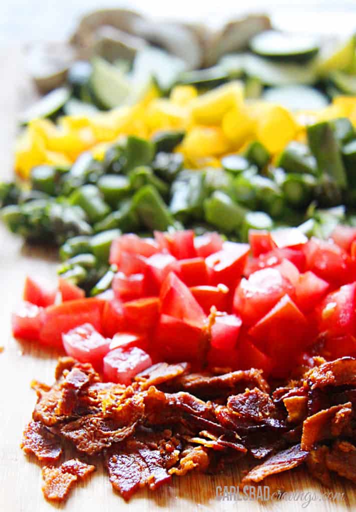 showing how to make savory crepes by chopping bacon, tomatoes, asparagus, bell peppers and mushrooms