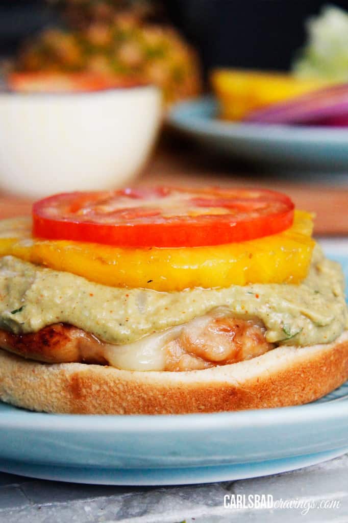 front view showing how to make Teriyaki Chicken Sandwiches by stacking teriyaki chicken with pineapple and tomatoes