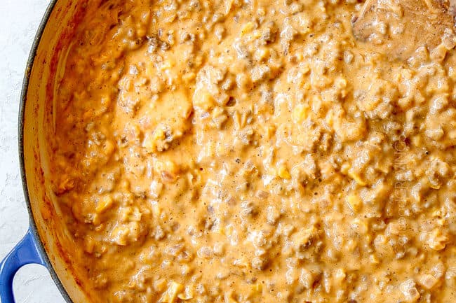 showing how to make buffalo mac and cheese by stirring until smooth