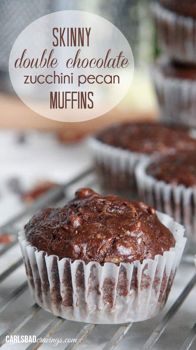 Chocolate Zucchini Muffins with DOUBLE the CHOCOLATE, ZERO added fat and a whole lot of yum!! This Chocolate Zucchini Muffins Recipe is baked with applesauce and vanilla yogurt that are crazy moist and chocolaty!ย You will devour these by the handfuls - becauseย you can! up close of healthy Chocolate Zucchini Muffins with chocolate chipis