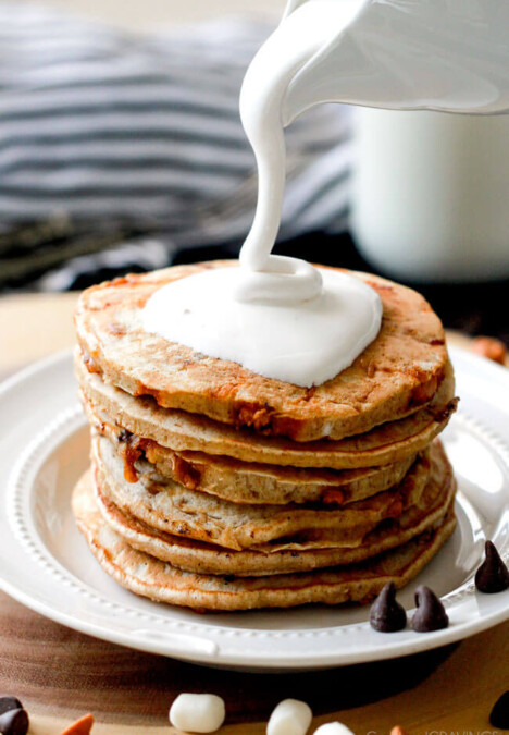 These AMAZING Fluffy S'mores Pancakes make the funnest breakfast or dessert and are super easy! My nieces and nephews beg me to make them and I have to admit I can't enough of the marshmallow syrup! Don't skip the butterscotch chips!