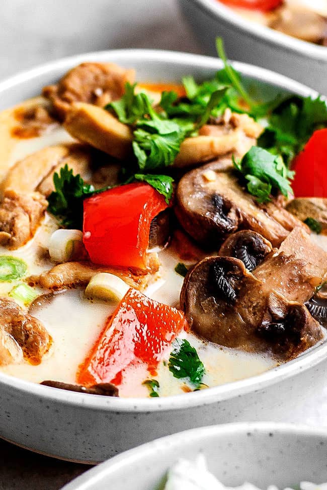 up close of tom kha gai recipe with a spoon