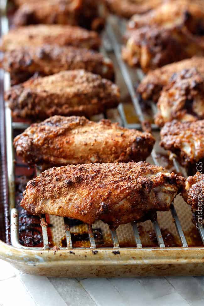 Close up view of chiken baked how to make Honey Buffalo Hot Wings on a baking rack.