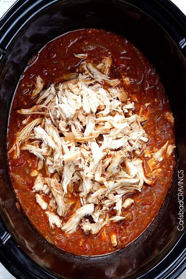 Crockpot Chicken Fajitas are the easiest way to make restaurant delicious chicken fajitas at home!ย Dump and simmer while you take a nap and let the citrus fiesta bath tenderize your chicken. showing how to make crockpot chicken fajitas by adding chicken to crockpot with orange juice, lime juice, green chilies, liquid smoke