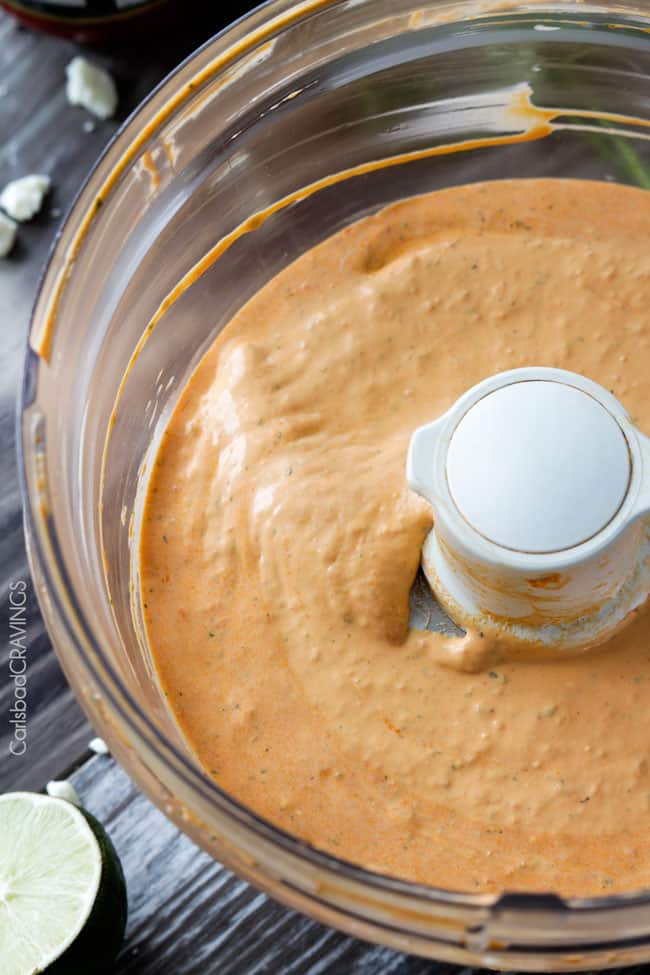 Showing how to make Roasted Red Pepper Feta Dip by blending in a food processor..