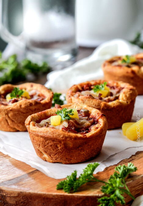 EASY Mini Deep Dish Hawaiian Pizzas baked in premade crescent dinner rolls for an easy buttery, fluffy crust and stuffed with your favorite Hawaiian pizza toppings smothered in a barbecue marinara. Fabulous appetizers or fun family meal and totally customizable - the possibilities are endless! #pizza #Hawaiian #Hawaiianpizza #mini