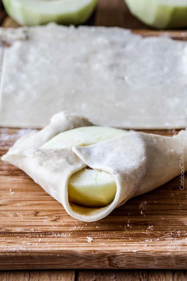 showing how to make apple dumplings recipe by folding dough over apples