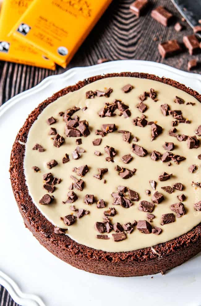 process shot showing how to assemble a chocolate cake with caramel frosting