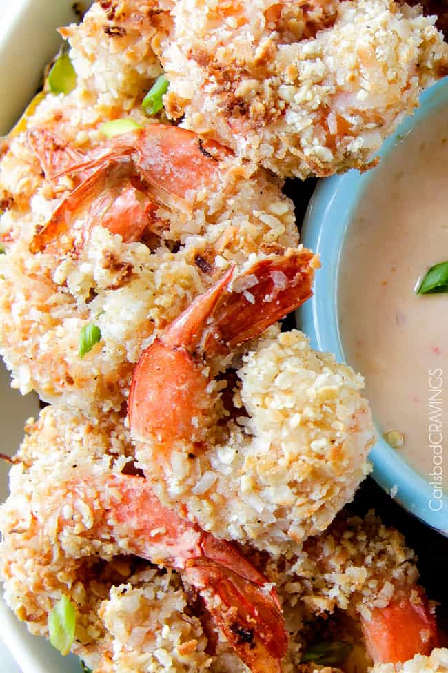 Baked crunchy, juicy Cashew Coconut Shrimp with Pineapple Sweet Chili Dip way better than takeout without the extra fat or cost! Close up texture of crispy Coconut Shrimp.