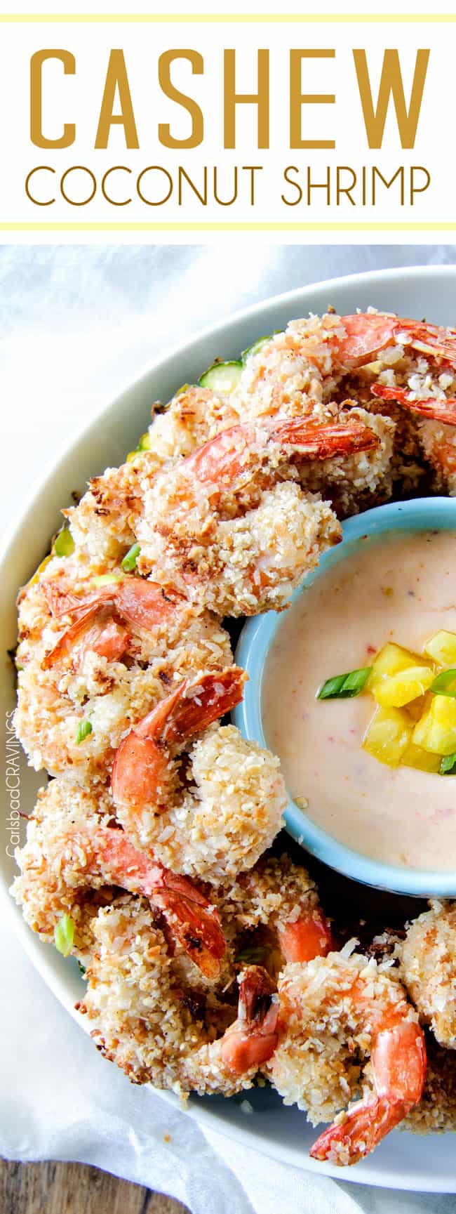 Baked crunchy, juicy Cashew Coconut Shrimp with Pineapple Sweet Chili Dip way better than takeout without the extra fat or cost! Coconut Shrimp on a platter next to dipping sauce.