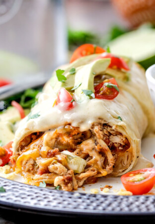 Easy Slow Cooker Shredded Mexican Chicken simmered with Mexican spices, salsa and green chilies for the BEST Mexican chicken perfect for tacos, burritos, tostadas, salads, etc. Couldnโt be any easier!