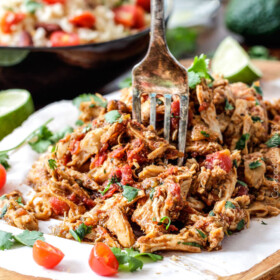 Easy Slow Cooker Shredded Mexican Chicken simmered with Mexican spices, salsa and green chilies for the BEST Mexican chicken perfect for tacos, burritos, tostadas, salads, etc. Couldnโt be any easier!
