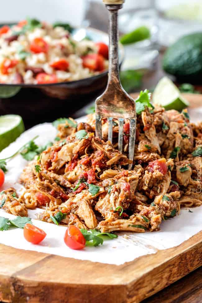 Easy Slow Cooker Shredded Mexican Chicken simmered with Mexican spices, salsa and green chilies for the BEST Mexican chicken perfect for tacos, burritos, tostadas, salads, etc. Couldnโt be any easier!