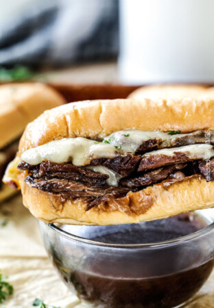 Crazy tender Slow Cooker French Dip Sandwiches seeping with spices are unbelievably delicious and make the easiest dinner or party food. You haven't had French Dip Sandwiches until you try these! absolutely the best!