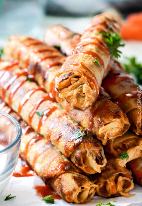 Super easy Slow Cooker Honey Buffalo Chicken Taquitos bursting with sweet heat cream cheese chicken filling you will want to eat it with a spoon! Perfect party appetizer that everyone will go crazy for or easy favorite meal!