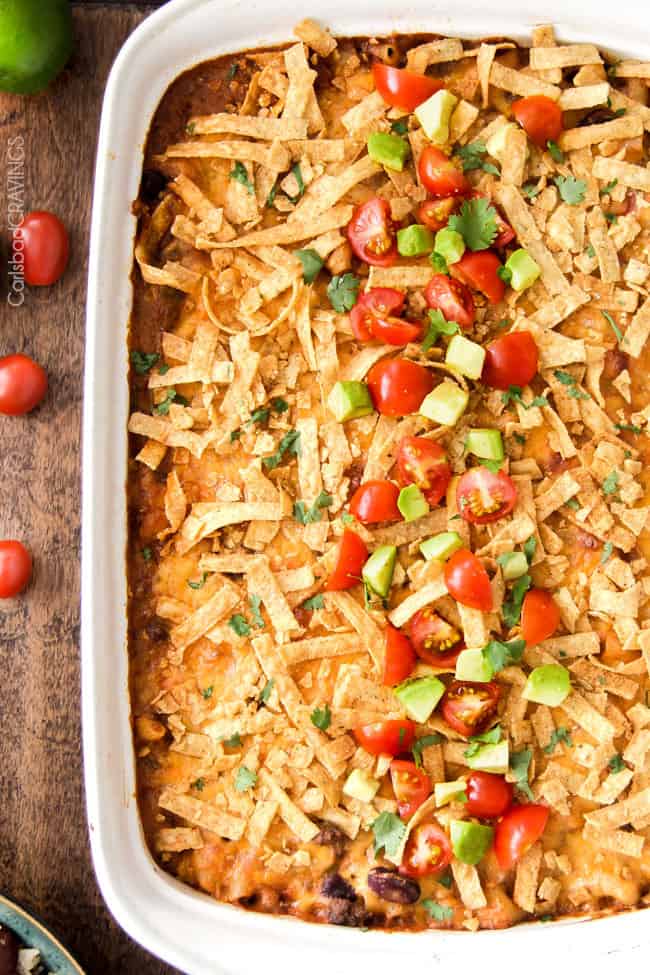 top view of taco pasta bake garnished with tortilla strips, tomatoes, and avocado.