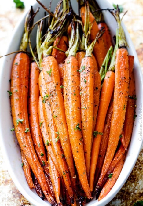 Tender, sweet and savory Secret Ingredient Honey Garlic Roasted Carrots are the most delicious carrots and easiest side dish EVER with only 10 minutes prep! I eat these like candy! #Thanksgiving #Easter #Christmas