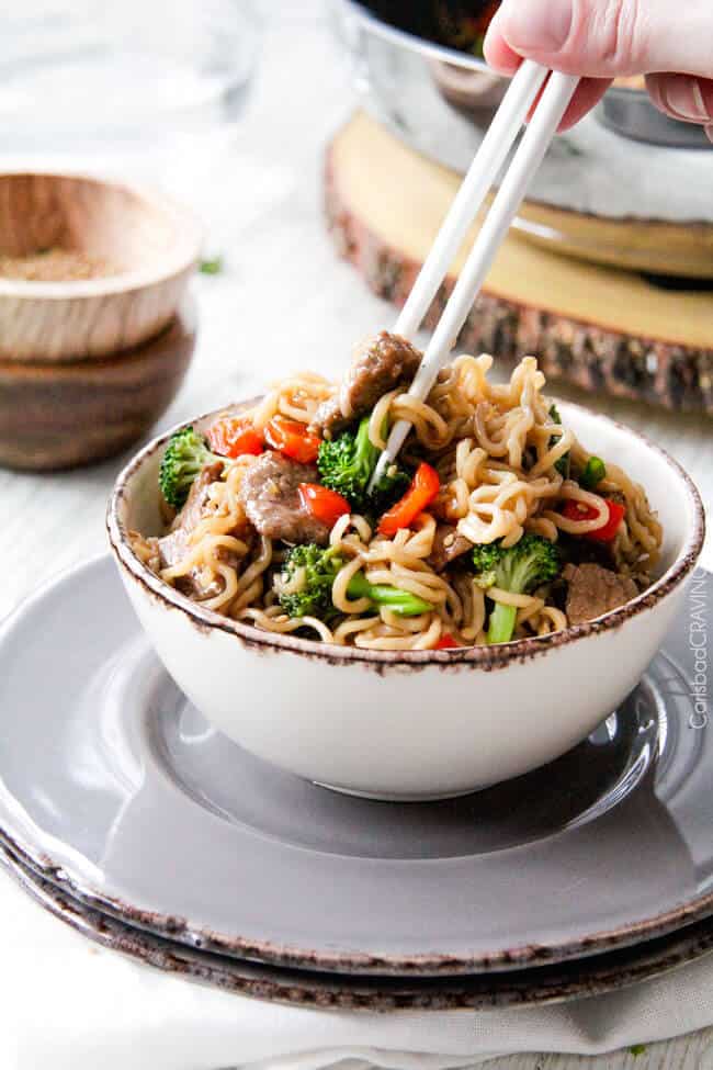 Beef and Broccoli Noodle Bowls eating with chopsticks.