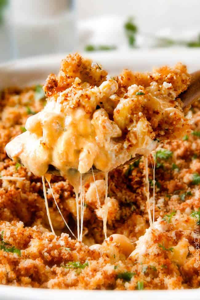 This mega creamy Million Dollar Macaroni and Cheese Casserole is the only macaroni cheese recipe you will ever want to make! make this for guests or family and they will love you forever! The homemade sauce itself is rich and crazy creamy and the casserole is stuffed with a hidden layer of provolone cheese and sour cream that melts when baked for a ridiculous amount of velvety creamy, cheesy goodness.