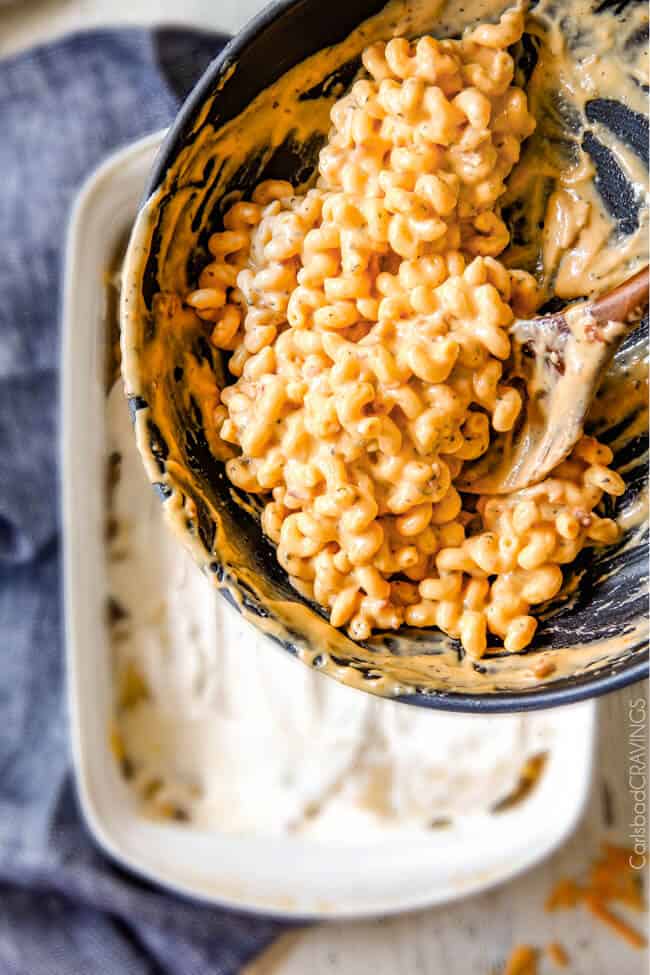 Adding Million Dollar Macaroni and Cheese to a pan to bake.