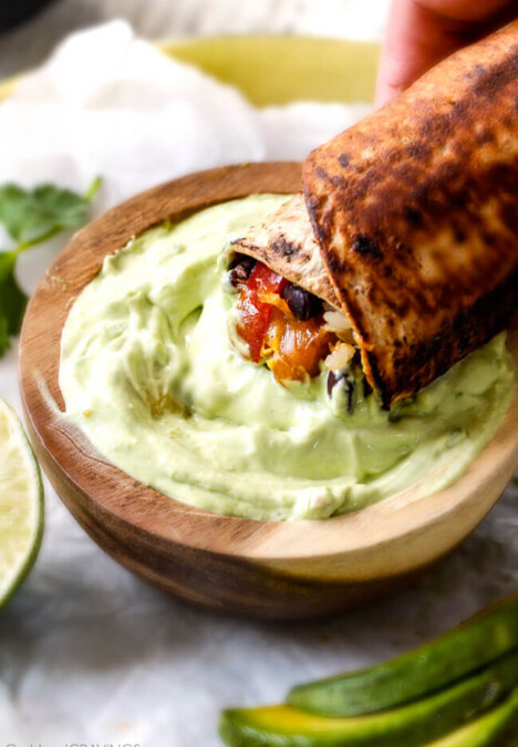 Chicken Fajita Wraps with Creamy Avocado Dip - layers of cheese, black beans, rice, the BEST chicken fajita filling, and sour cream all rolled up then skillet toasted for slightly crispy wraps that are absolutely addicting!! This is our family's favorite way to eat leftover chicken fajita filling!