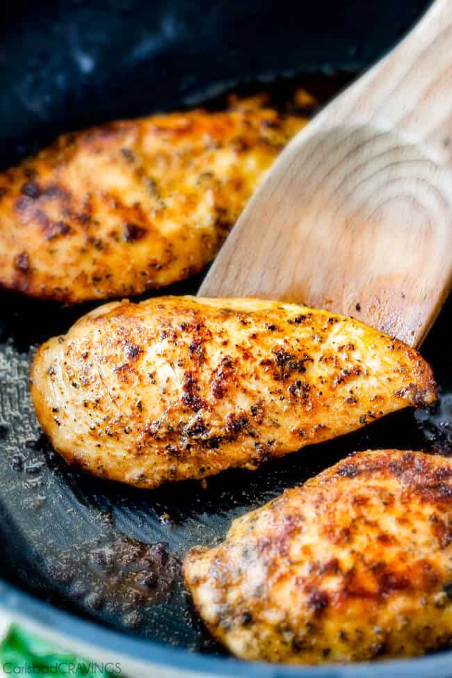 Showing how to make Maple Dijon Chicken Skillet by cooking the chicken in a frying pan.