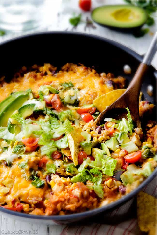 mexican chicken and rice with toppings in skillet