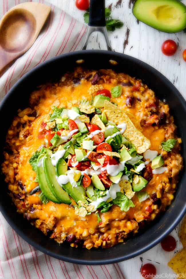 Top view of Mexican Chicken and Rice with tomatoes and sour cream.