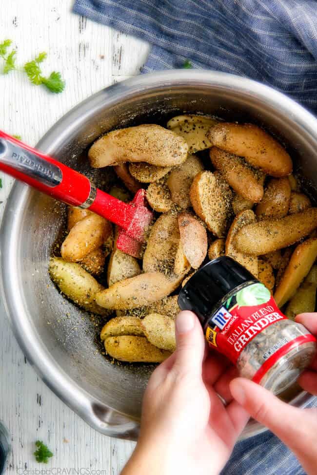 Showing how to make Baked Parmesan Fingerling Potato Fries adding spices.