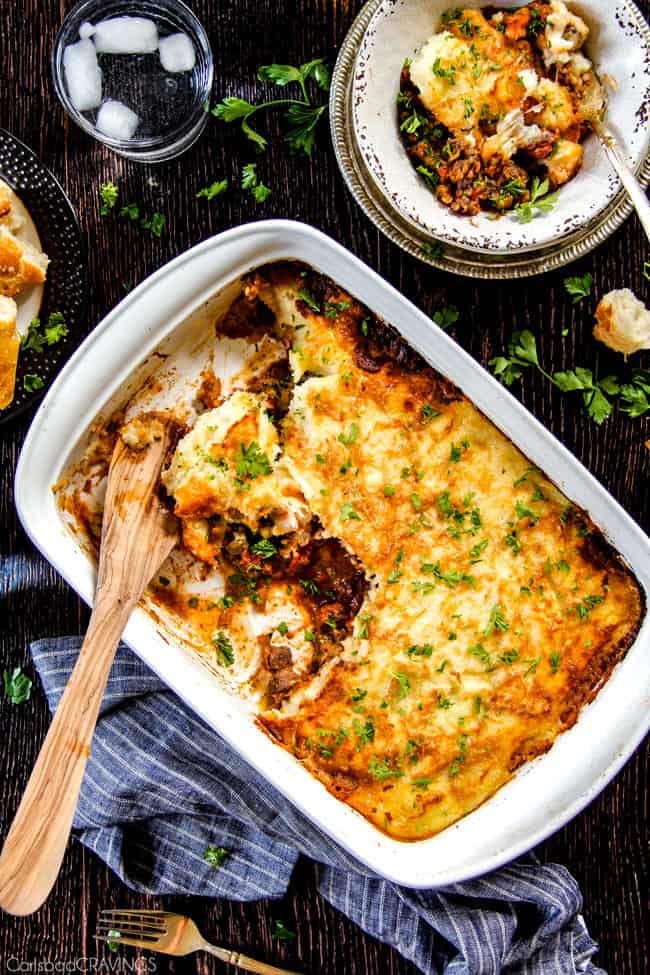 Savory, comforting Boneless Short Rib Shepherd's Pie elevates shepherd's (or cottage pie) to a whole new level with melt in your mouth meat and Swiss Gruyere Mashed Potatoes! This is guaranteed to be a new family favorite!!! top view of the perfect shepherd's Pie in a white casserole dish