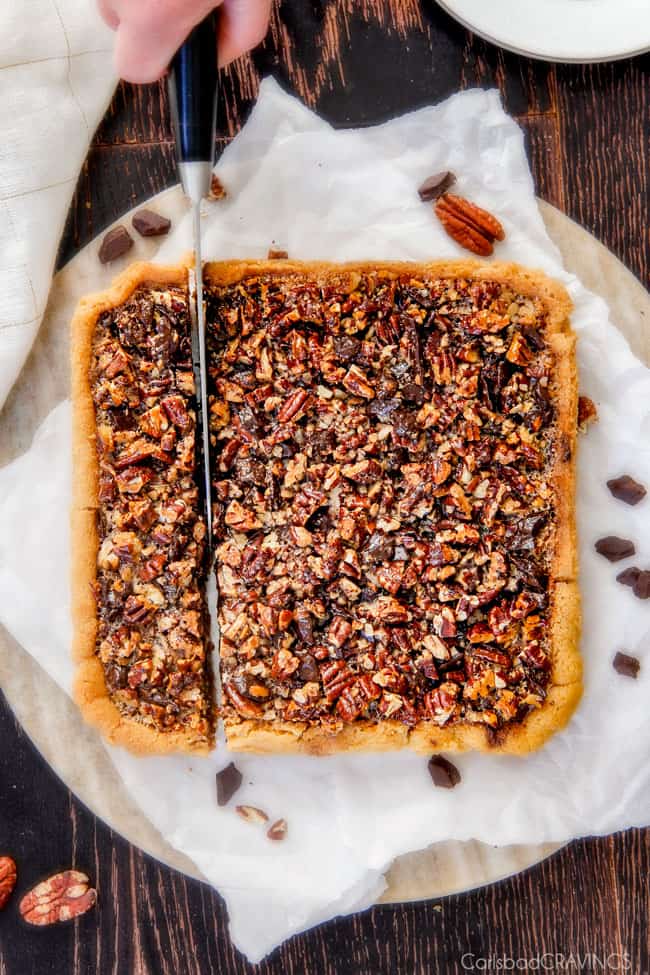 Showing how to cut a pan of Chocolate Chunk Pecan Pie Bars.
