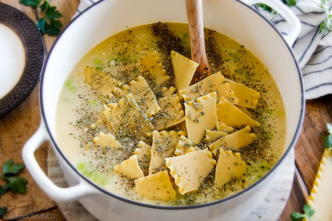 Showing how to make White Chicken Lasagna Soup adding pasta to the pot.