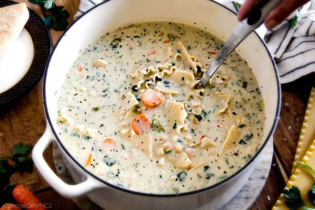 Showing finished White Chicken Lasagna Soup in a white pot.