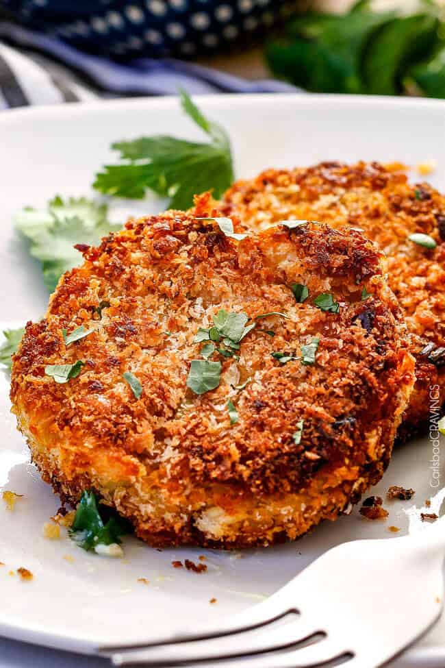 Easy, extra crispy, restaurant quality Crab Cakes right in your own home! Crispy on the outside, moist, juicy, flavor packed on the inside with the BEST DIP ever!! You can also make ahead of time for stress free appetizers! up close view of a crispy crab cake on a white plate with crab cake sauce