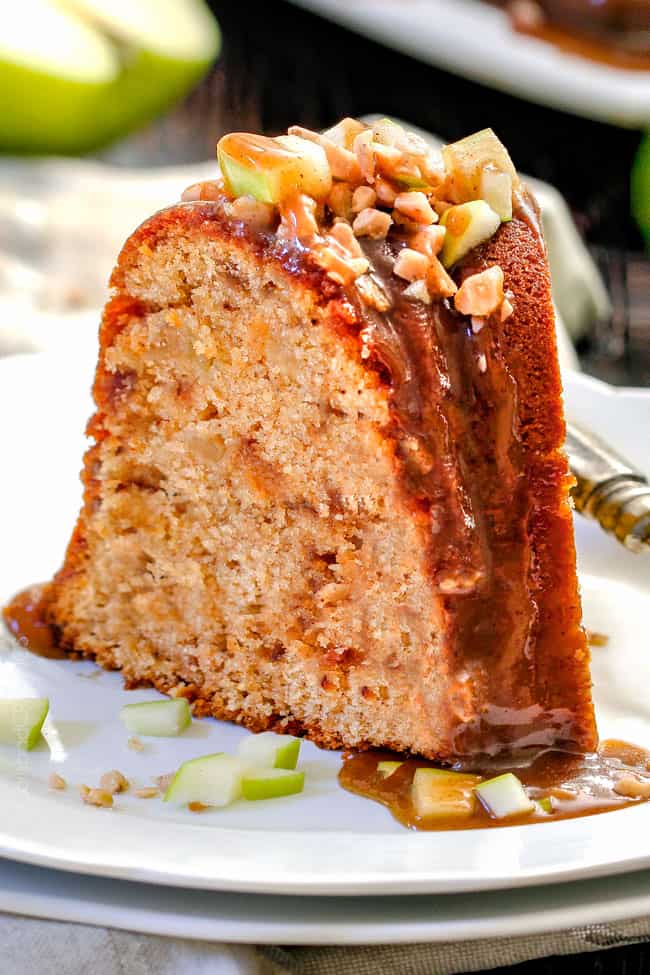 a slice of apple pound cake topped with caramel sauce, toffee bits, and chopped apple.