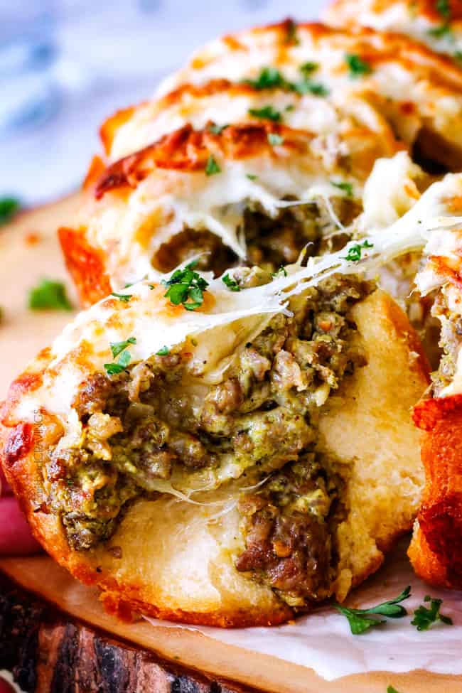 Close up of Cheesy Sausage Pesto Ring pulling apart.