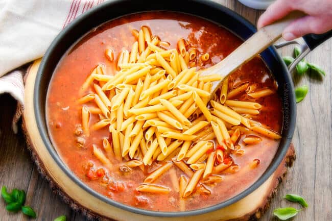 One Skillet Cheesy Penne - the best homemade ragu sauce simmered right with the pasta then loaded with cheese! My family begs me to make this weekly!