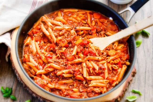 One Skillet Cheesy Penne - the best homemade ragu sauce simmered right with the pasta then loaded with cheese! My family begs me to make this weekly!