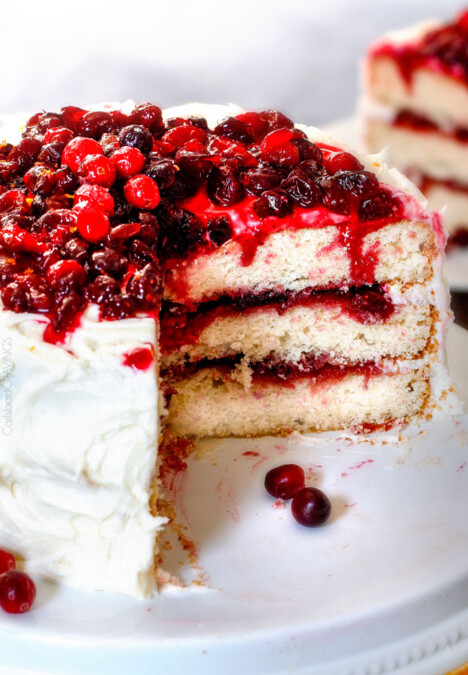 White Cake with Cranberry Filling and Buttercream Frosting – everyone always asks me for this recipe! The moist, bakery style white cake is the BEST ever and the sweet and tangy cranberry filling is melt in your mouth delicious and Christmas festive!