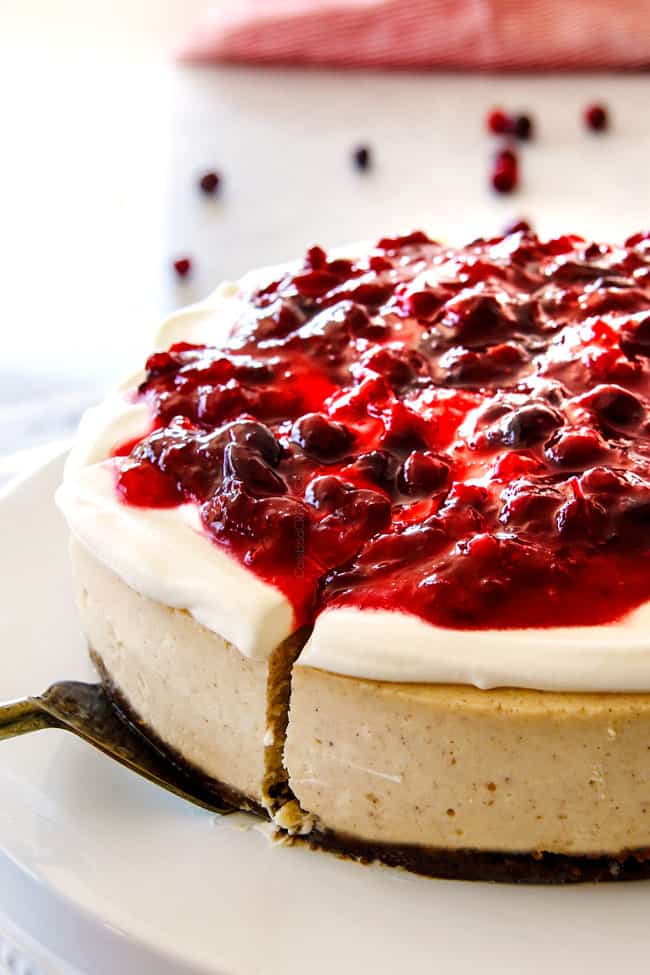 Serving a slice of Cranberry Eggnog Cheesecake