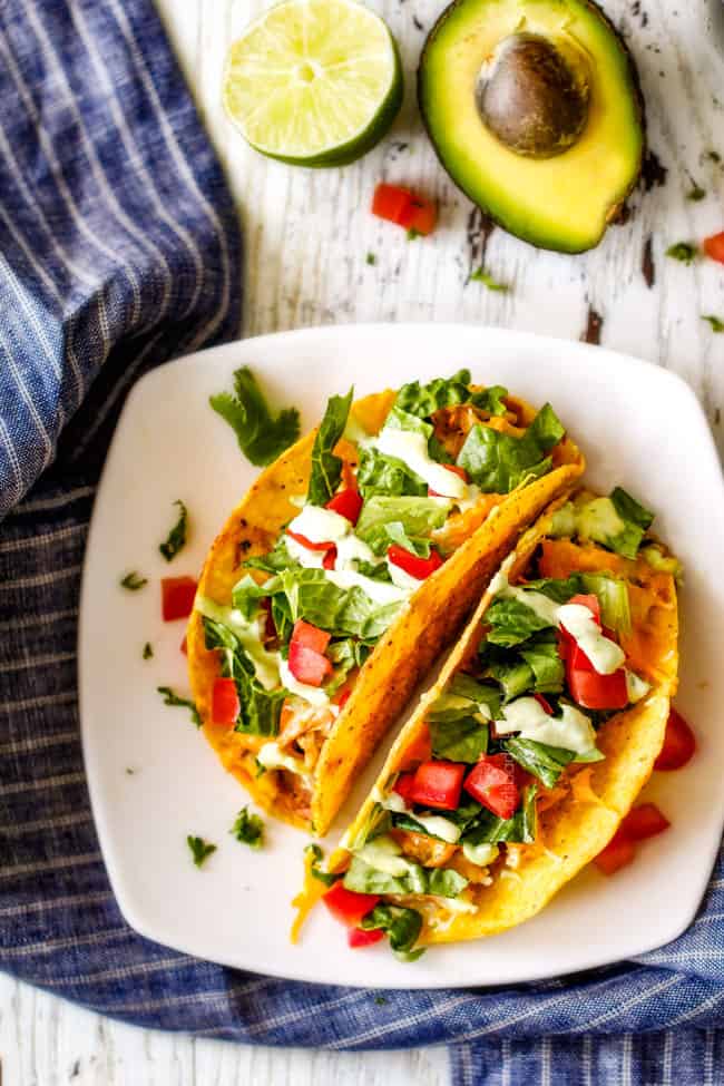 Slow Cooker Fiesta Ranch Cream Cheese Chicken is wonderfully creamy, seasoned to perfection and is as easy as dump and run! It makes the perfect make ahead filling for taquitos, tacos and burritos! adding Cream Cheese Chicken to tacos