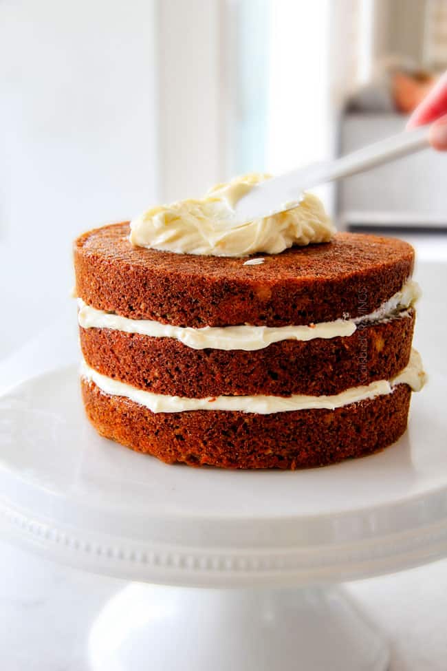 Layered Carrot Cake with Pineapple Cream Cheese Frosting - This is the BEST Carrot Cake Recipe, I will never make another recipe again! ! Super moist without being oily, spiced perfectly, and the Pineapple Cream Cheese Frosting is incredible! Brought this to a party and everyone was BEGGING me for the recipe! Showing how to shred carrots on cheese grater for easy carrot cake recipe