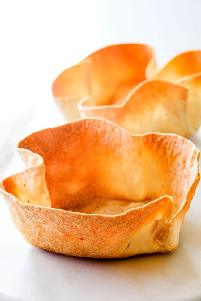 showing how to make tortilla bowls to serve taco salad by baking until crispy