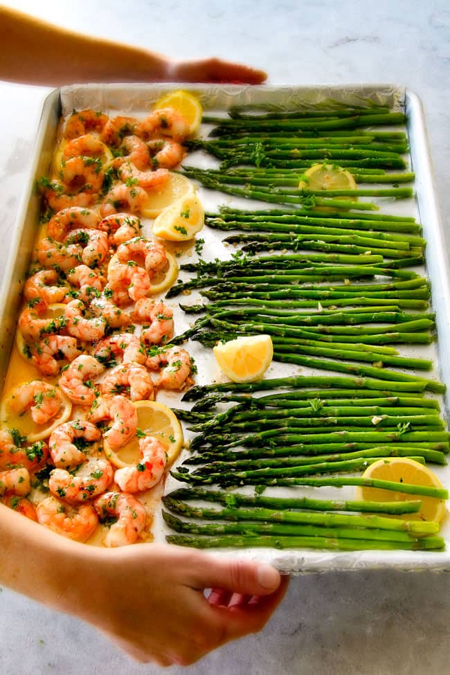 Showing hoe to make Roasted Lemon Garlic Butter Shrimp and Asparagus