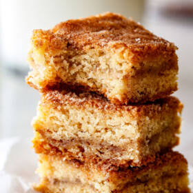 Incredibly EASY, thick, soft and chewy, buttery Snickerdoodle Cookie Bars taste just like the cookie but so much easier and less time consuming! The cinnamon and sugar crackle top is to die for!