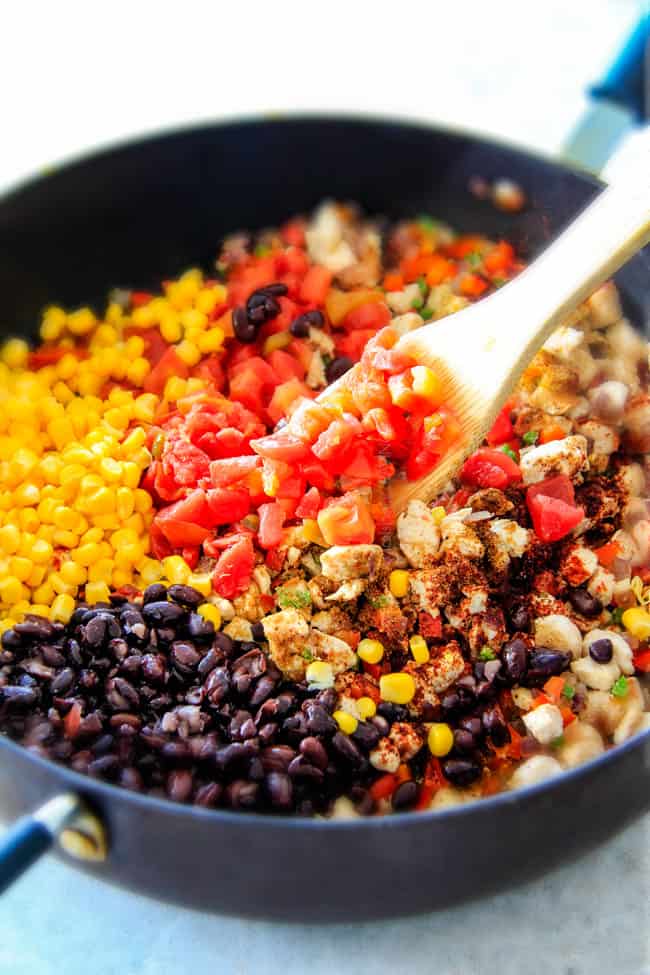 showing how to make Southwest Egg Rolls by mixing chicken, beans, tomatoes, rice, avocado and cheese together in a pan