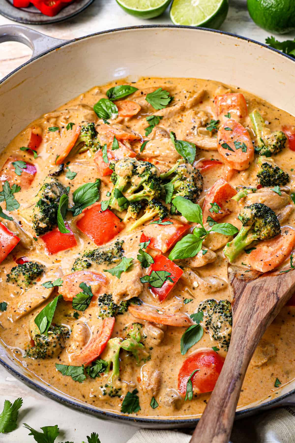 Thai red curry recipe in a spot with a spoon showing how creamy it is